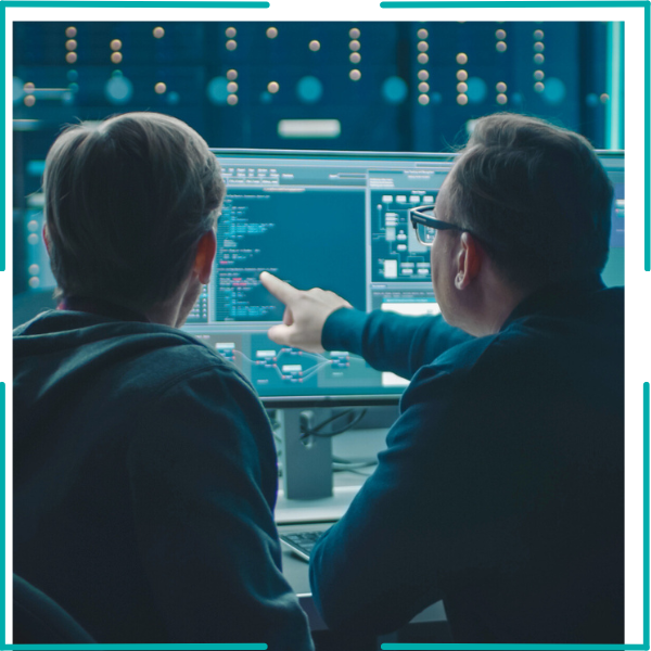 Two security experts performing managed application security testing on dynamic systems in a secure operations center.